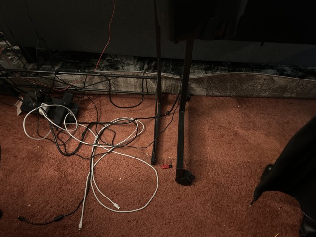 Image of a rug being pulled up over two desk legs.